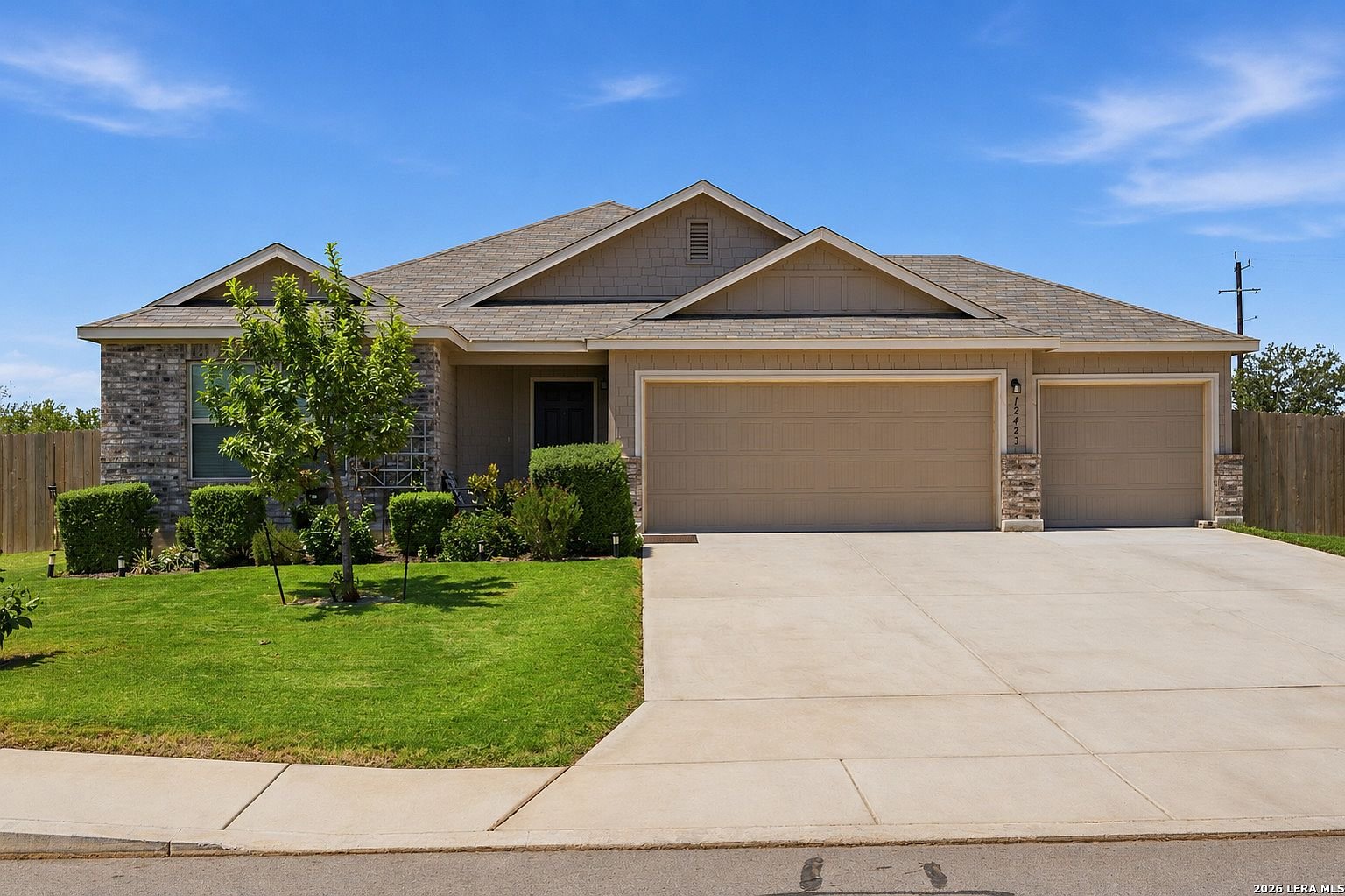 Front exterior of 12423 Autumn Way with three-car garage